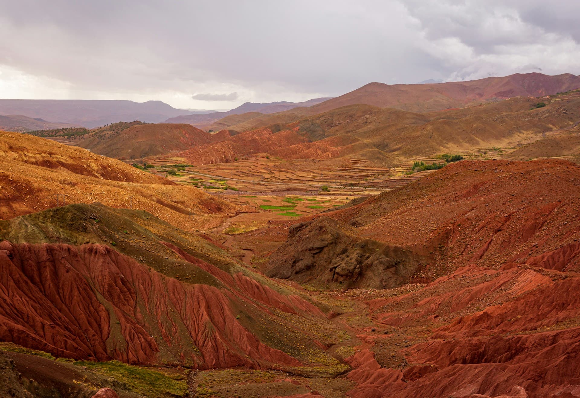 Majestic Atlas Mountains with dramatic peaks and valleys under a clear sky, showcasing the natural beauty of Morocco.